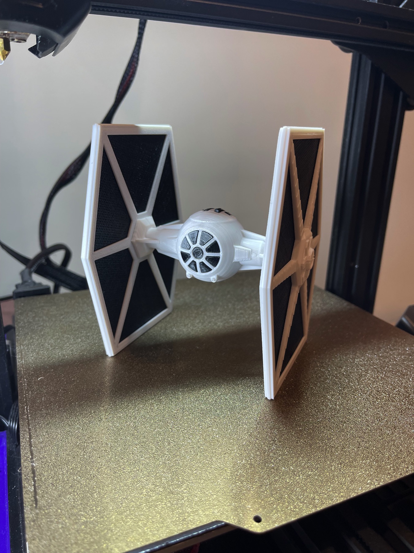 3d printed tie fighter model in a white and black color scheme.